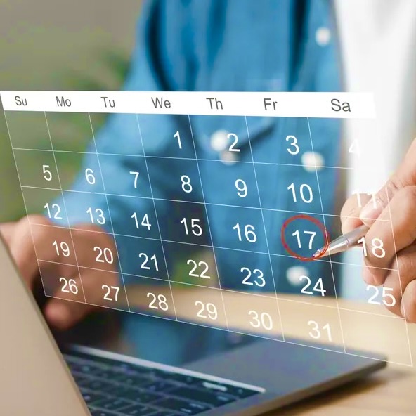 A person is using a laptop to view the calendar.